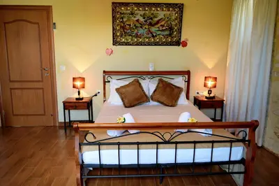 a bedroom with a bed with two lamps on two tables at Chania's Diamond Villas - Aqua Bliss with Private Pools in Gavalochori