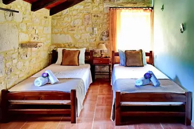 a bedroom with two beds with towels on them at Chania's Diamond Villas - Aqua Bliss with Private Pools in Gavalochori