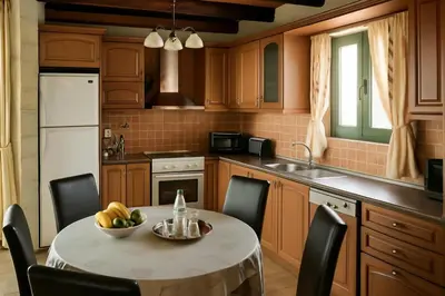 a kitchen with a table with a bowl of fruit on it at Chania's Diamond Villas - Aqua Bliss with Private Pools in Gavalochori
