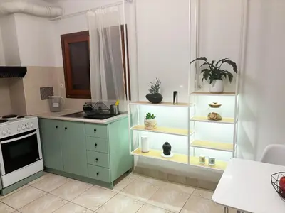 a kitchen with green cabinets and a stove at Gardenia Maisonette Rooftop Old Town View in Chania Town