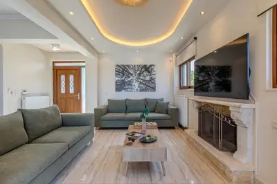 a living room with a couch and a fireplace at Anna by Vintage Travel in Troúlous