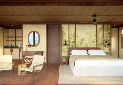 a bedroom with a bed and a table and a chair at The Revery, Elafonisi - Member of Leading Hotels of the World in Livadia