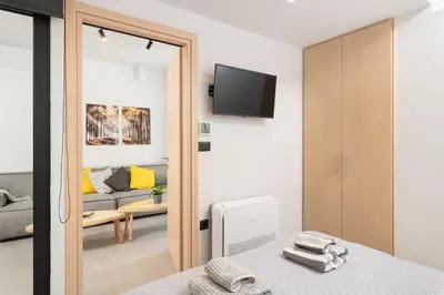 a room with a bed and a living room at Ethea Residences-Thalia in Chania Town
