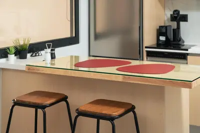 a kitchen with two stools at a counter at Ethea Residences-Helia in Chania Town