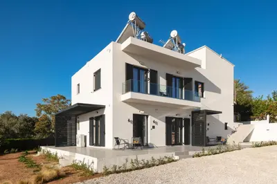 a white house with black doors and windows at Ethea Residences-Helia in Chania Town