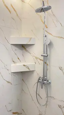 a shower in a bathroom with marble walls at MP Apartments in Chania Town