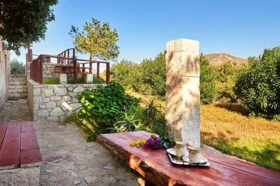 a wooden bench with flowers on top of it at La Irilia Residences & Retreat in Agios Padeleimon