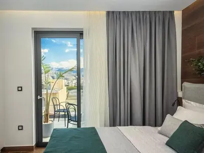 a hotel room with a bed and a balcony at Amazing views in Chania Town