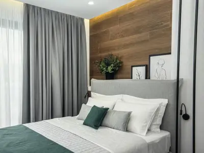 a bedroom with a bed with white and green pillows at Amazing views in Chania Town