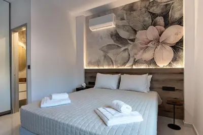 a bedroom with a bed with two towels on it at Lumera Urban Stay - New 2BR Home with Private Parking near Old Town in Chania Town