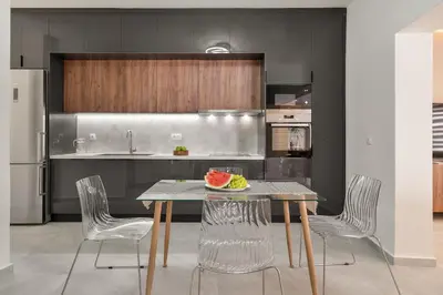 a kitchen with a table with a plate of fruit on it at Coralie 3 bedroom apartment 40m from the beach in Chania Town