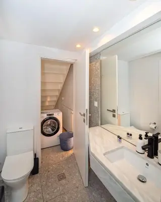 a bathroom with a toilet and a sink at Central cozy garden flat in Chania Town