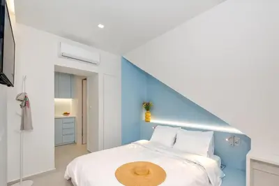 a bedroom with a bed with a blue wall at Αthena Studio 3 in Chania Town
