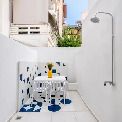 a white balcony with a white table and blue flooring at Athena Studio 1 in Chania Town