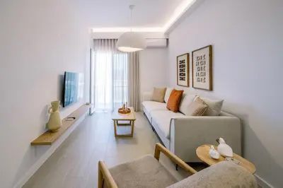 a living room with a couch and a table at Terra Chic Retreat Suite in Chania Town