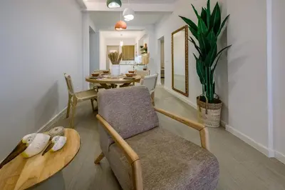 a living room with a chair and a table at Terra Chic Retreat Suite in Chania Town