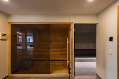 a room with a glass door leading into a bedroom at Only View Villa - Timeless Coastal Retreat by etouri in Chania