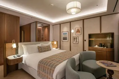 a hotel room with a large bed and a table at Hilton Chania Old Town Resort & Spa in Chania Town