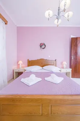a bedroom with a large bed with two white towels at Creta Sea View 2BR Maisonette by ΜΡS in Marathokefála