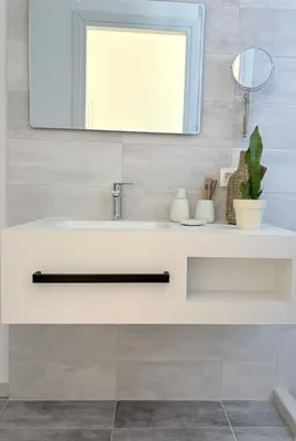 a bathroom with a white sink and a mirror at Athina's Cozy Guest House in Kamisianá