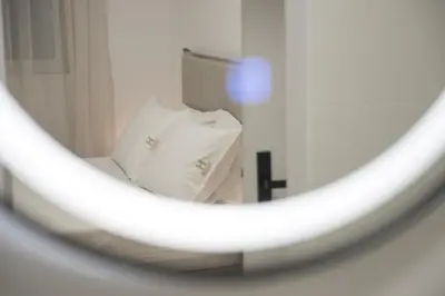 a reflection of a bed in a mirror at Hanim 2BR Loft Apartment - Garden & Indoor Parking in Chania Town