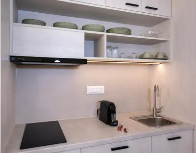a kitchen counter with a sink and a microwave at BŌW 1st Floor Luxury Apt -Heart of Chania Old Town in Chania Town