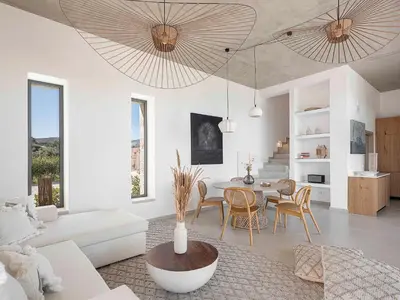 a living room with a white couch and a table at Himmel Villas - Seaview luxury & private pools in Kalivianí