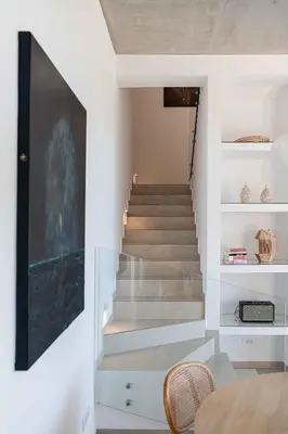a staircase in a house with white walls at Himmel Villas - Seaview luxury & private pools in Kalivianí