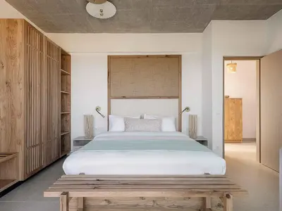 a bedroom with a large bed and two lamps at Himmel Villas - Seaview luxury & private pools in Kalivianí