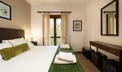 a bedroom with a large white bed and a window at Villa Eleni Meskla in Mesklá