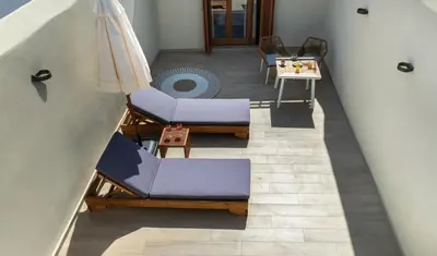 an overhead view of a living room with chairs and an umbrella at BŌW 2nd Floor Luxury Apt -Heart of Chania Old Town in Chania Town