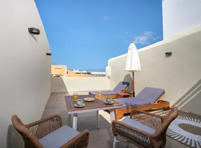 a table and chairs on a balcony with a view at BŌW 2nd Floor Luxury Apt -Heart of Chania Old Town in Chania Town