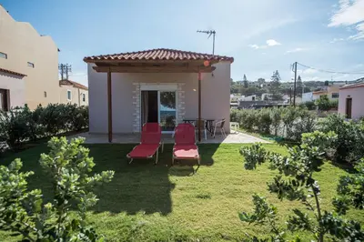 a backyard with two chairs and a gazebo at Lila Villas in Stalos