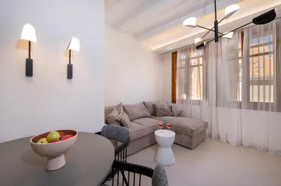 a living room with a couch and a table at Bow Complex Apartment- In the Heart of Old Harbour in Chania Town