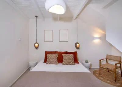 a bedroom with a bed with two pillows on it at Bow Complex Apartment- In the Heart of Old Harbour in Chania Town