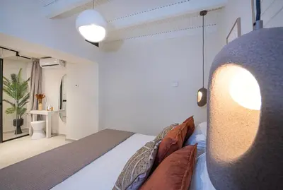 a bedroom with a bed and a living room at Bow Complex Apartment- In the Heart of Old Harbour in Chania Town