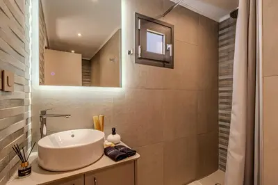 a bathroom with a sink and a mirror at Seawhisper Villa in Kalyves