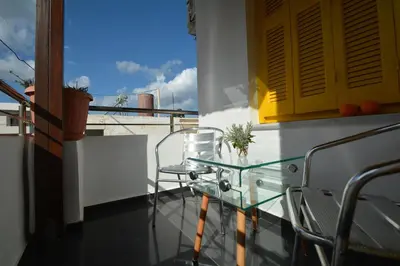 a balcony with two chairs and a glass table at Agapi in Kissamos