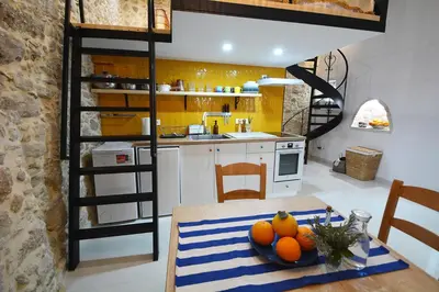 a kitchen with a table with a bowl of oranges on it at Agapi in Kissamos