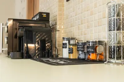 a counter top with a coffee maker and a microwave at La Petite Fleur City apartment Chania in Chania Town