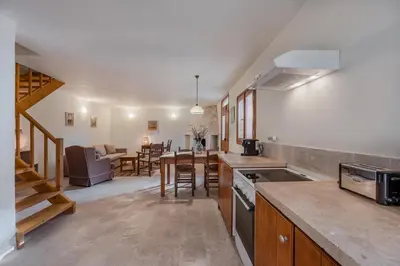 a kitchen and living room with a table and chairs at Vamos villa in Vamos