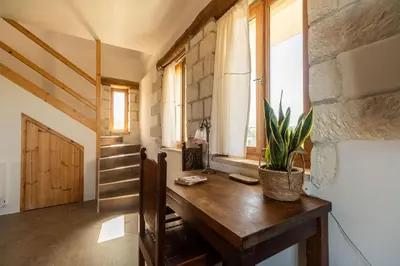 a room with a wooden table with a plant on it at Villa Falcos by PosarelliVillas in Gavalochori