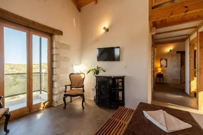 a living room with a chair and a window at Villa Falcos by PosarelliVillas in Gavalochori