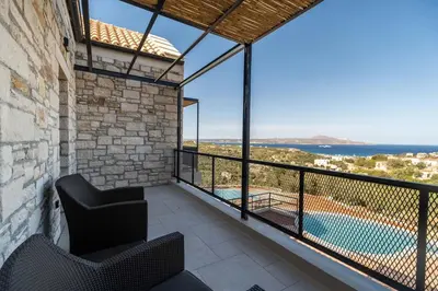 a balcony with a view of a swimming pool at Villa Seiri by PosarelliVillas in Gavalochori