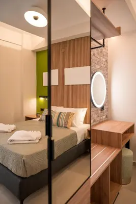 a bedroom with two beds and a mirror at Chania Experience Residence in Chania Town