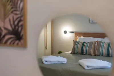 a bedroom with a bed with two towels on it at Chania Experience Residence in Chania Town