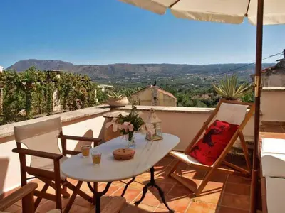 a table and chairs on a balcony with a view at Holiday Home in Douliana mit Großem Balkon by Interhome in Douliana