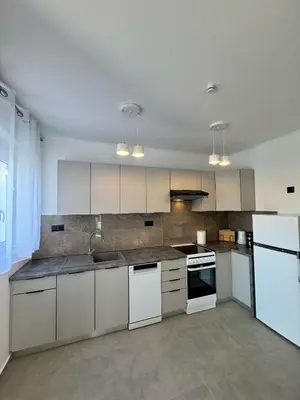 a kitchen with white cabinets and white appliances at Villa & Apartament Armonia 2 Sol Aura Gavalochori - Vamos KRETA in Vamos