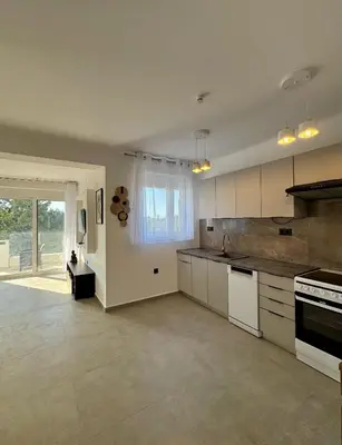 a large kitchen with white cabinets and a large window at Villa & Apartament Armonia 2 Sol Aura Gavalochori - Vamos KRETA in Vamos