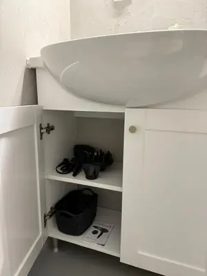 a white bathroom cabinet with a sink in it at Oneiro Apartment in Kounoupidhianá